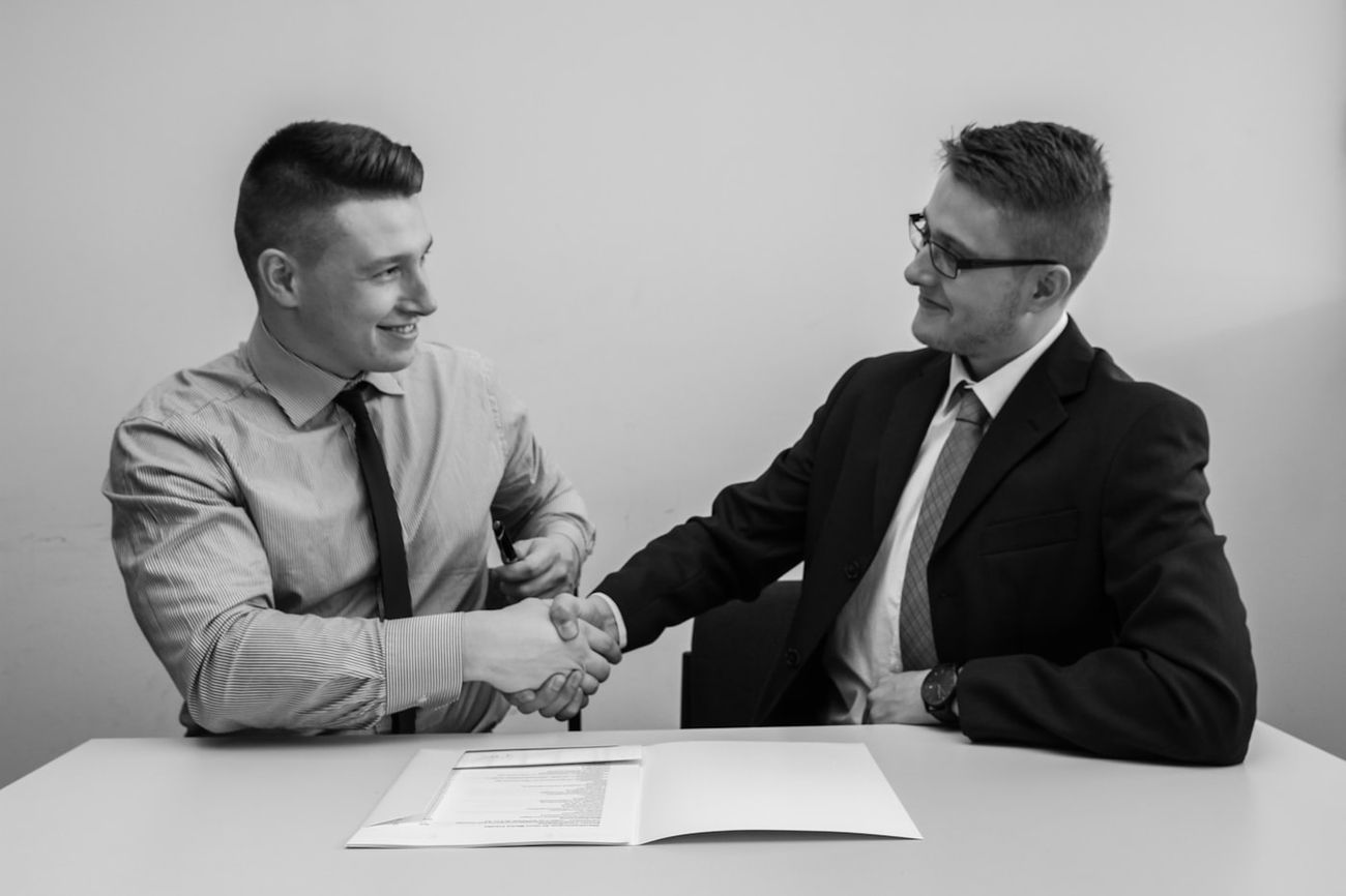 Two colleagues shaking hands in mutual agreement